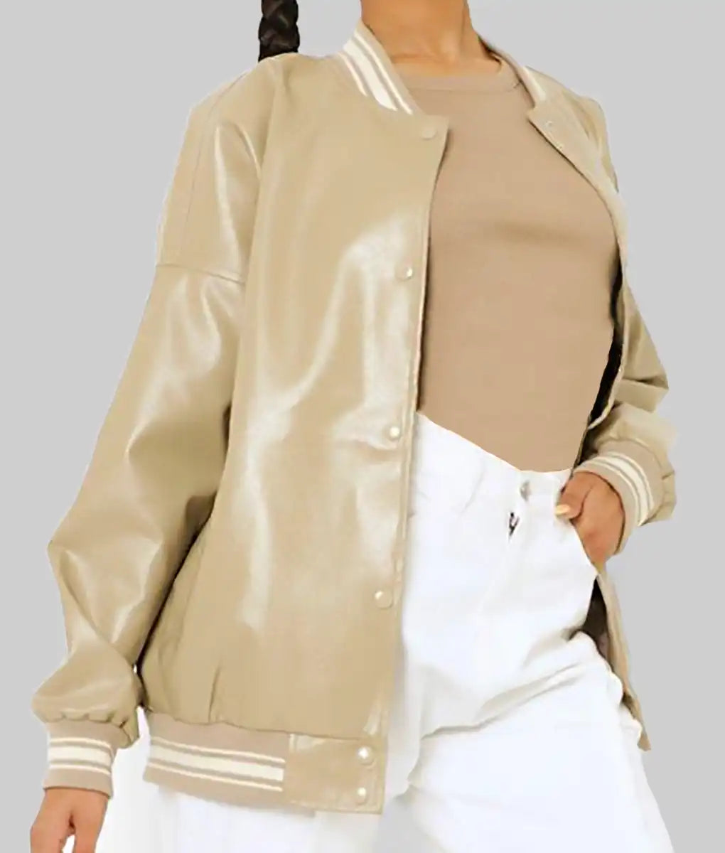 Beige leather varsity jacket for women styled with a tan top and white pants