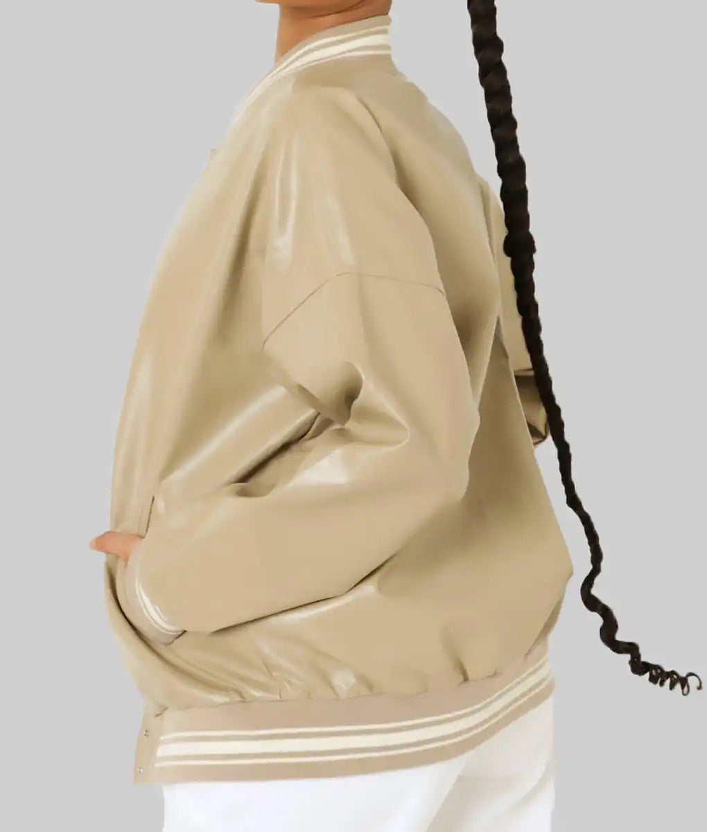 Beige leather varsity jacket for women by Lush Gear shown from side with striped cuffs and hem