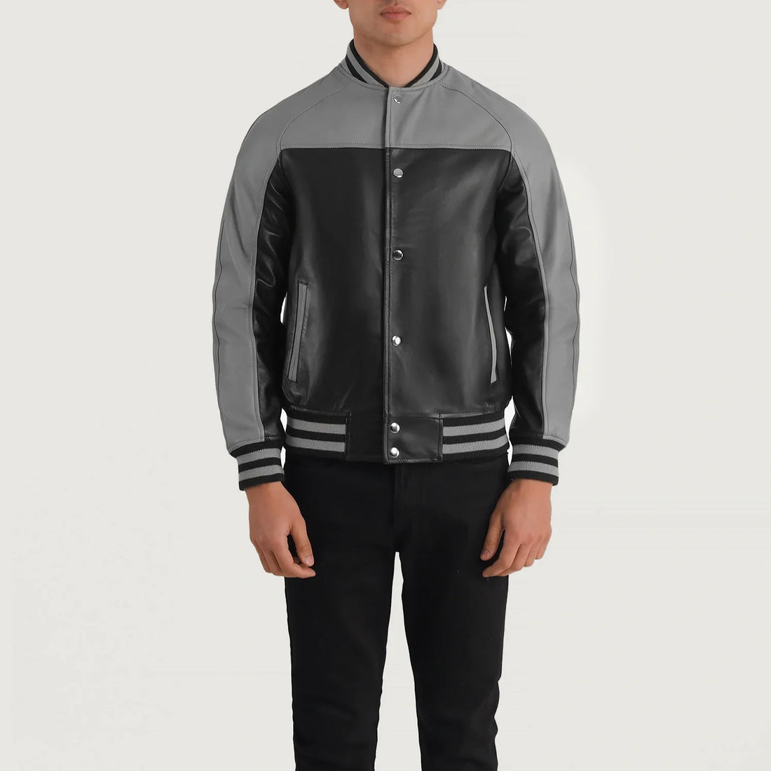Black and grey leather varsity jacket by Lush Wear on male model with striped cuffs and collar