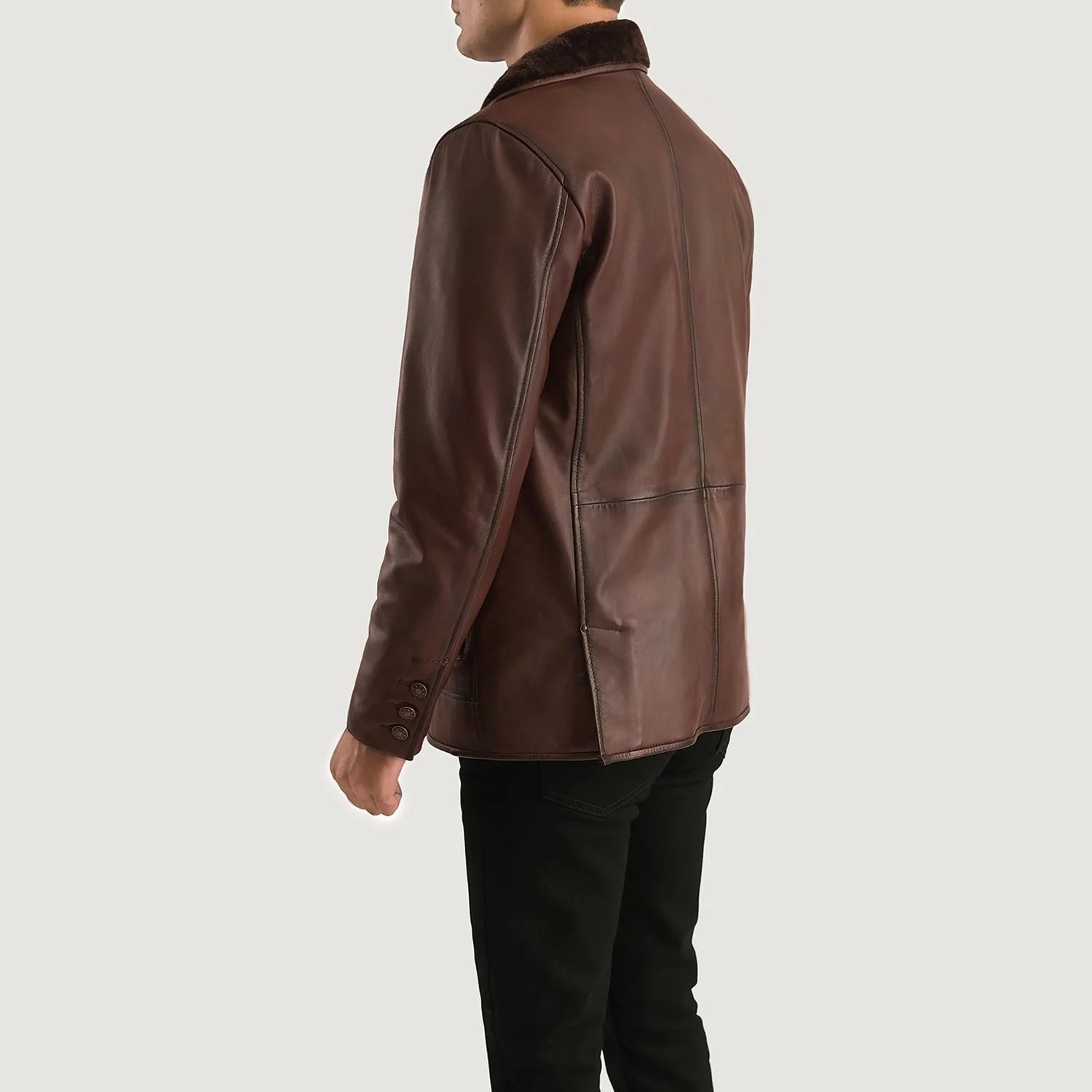 Back view of brown fur leather coat on male model featuring long sleeves and rear vent