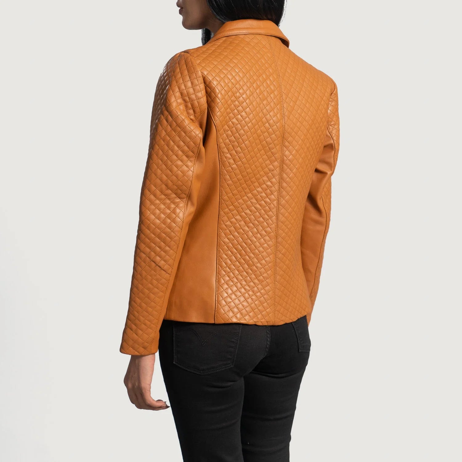 Back view of a woman wearing Cora Quilted Brown Leather Blazer from Lush Gear with diamond quilted pattern