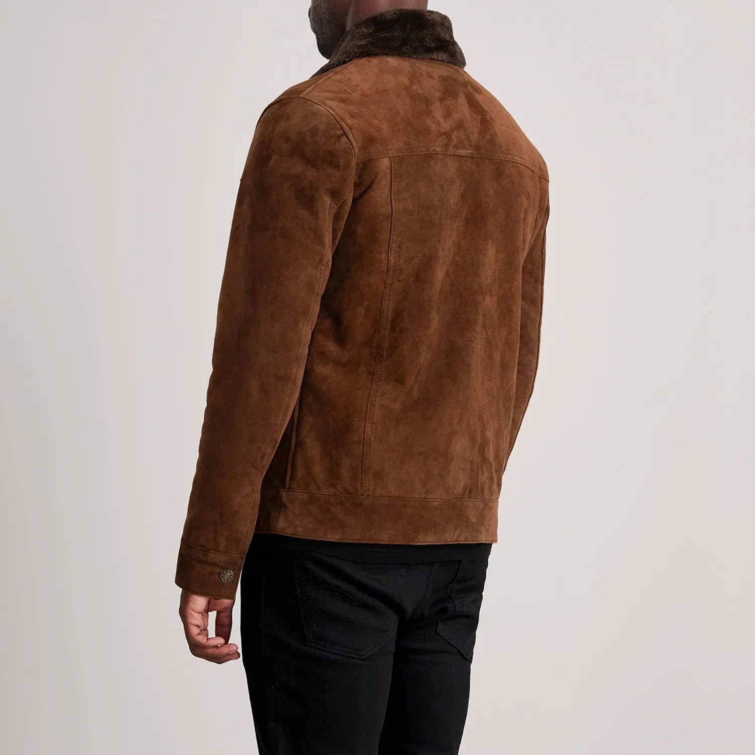 Back view of man wearing dallis brown trucker jacket with fur collar and suede finish