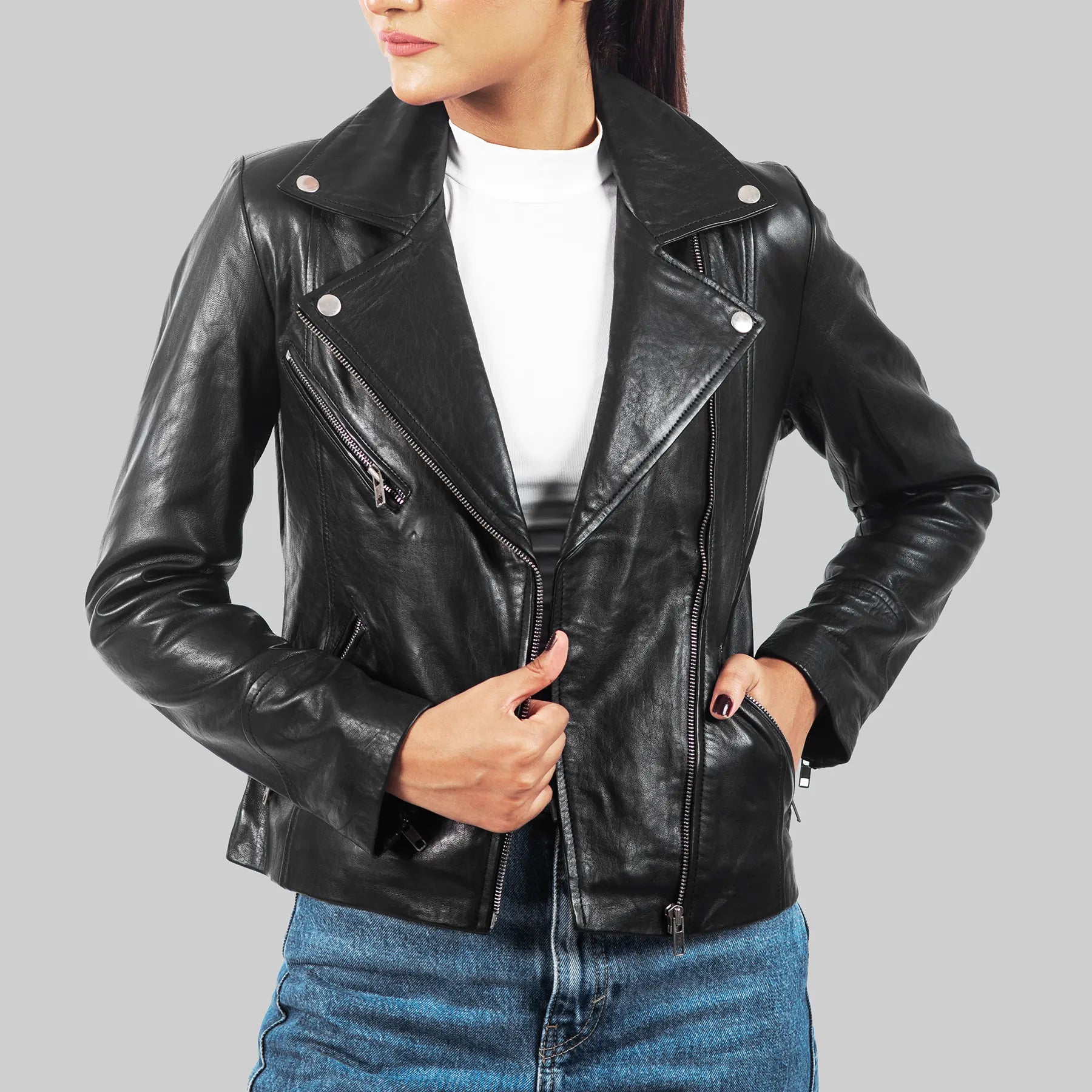 Black leather motorcycle jacket for women with zippered pockets and silver button details