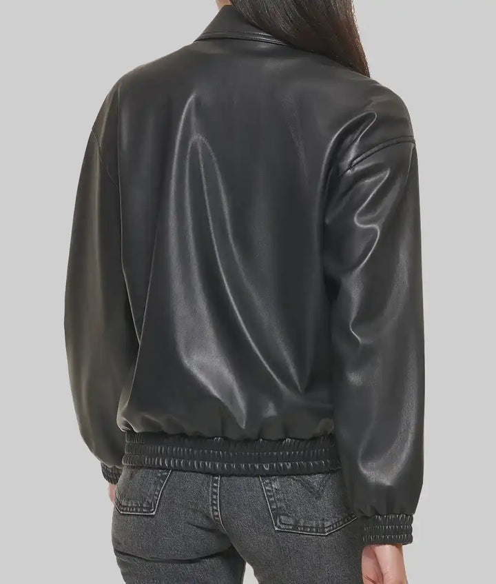 Black leather varsity jacket for women with ribbed cuffs and waistband shown from the back