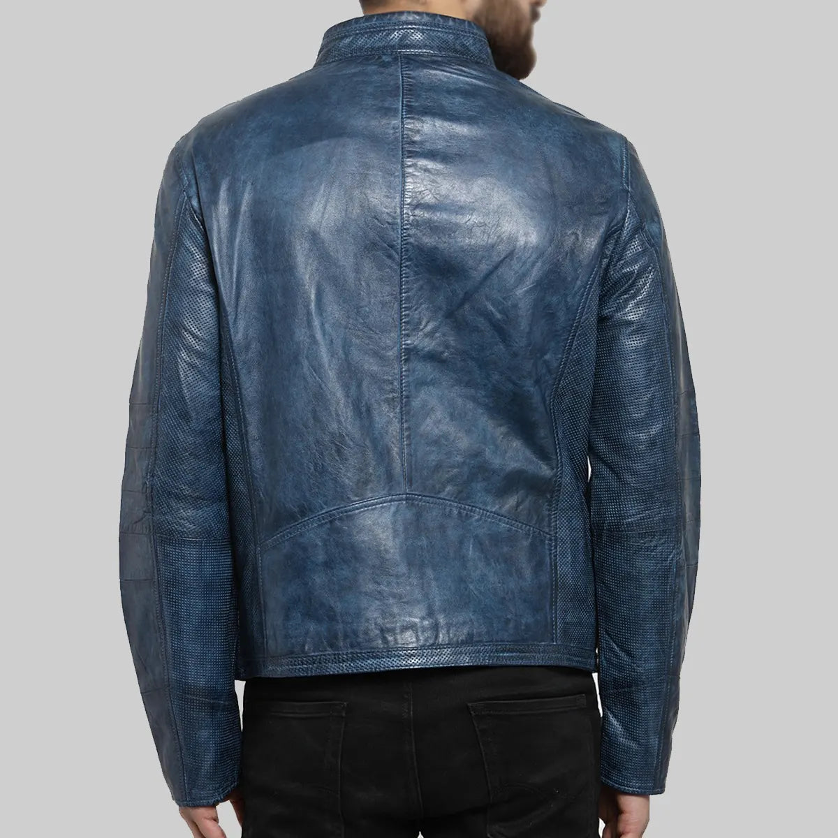 Back view of blue distressed leather biker jacket by Lush Gear worn by man with black pants