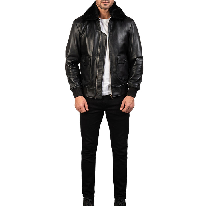 Mens shearling leather bomber jacket in black with fur collar worn over white shirt and black pants