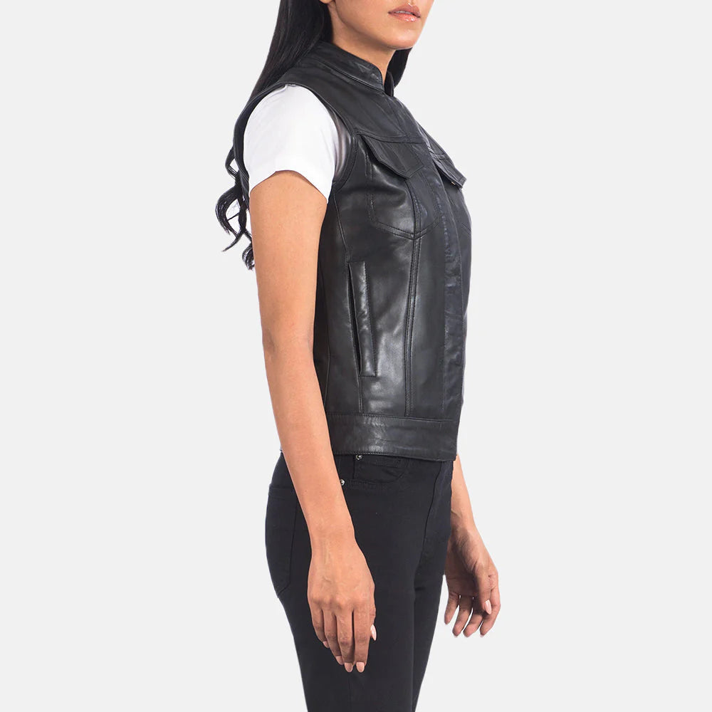 Side view of Rayne Moto Black Leather Vest worn by woman over white shirt and black pants