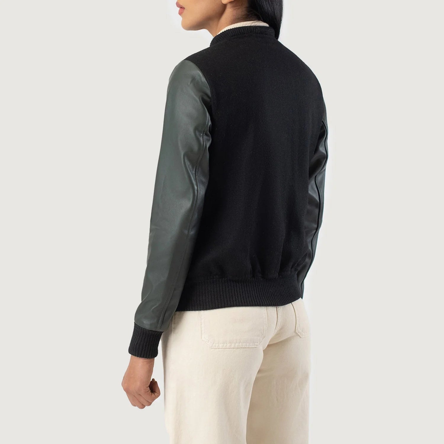 Back view of Savant Green & Black Hybrid Varsity Jacket by Lush Gear worn with cream pants