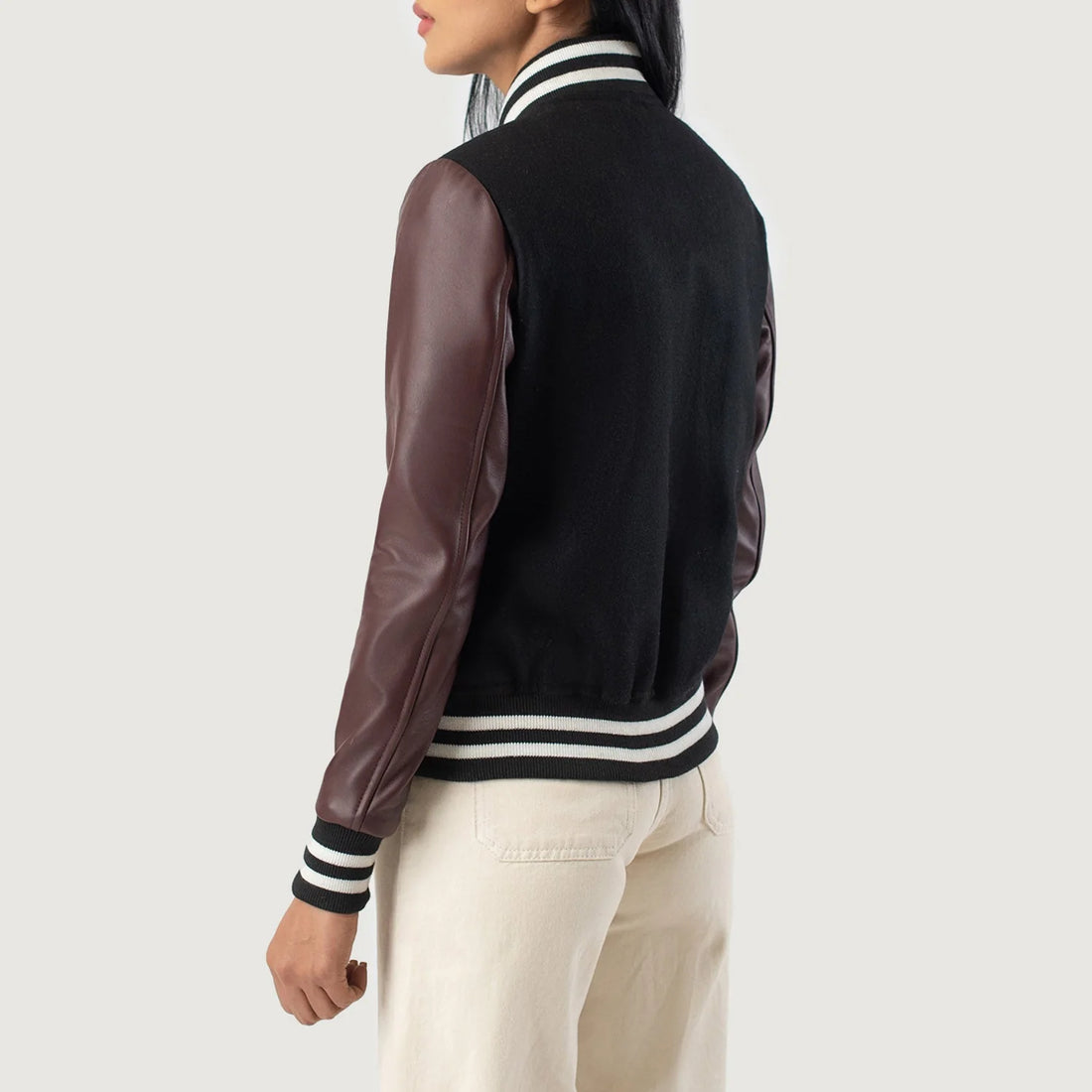 Back view of woman wearing Savant Maroon & Black Hybrid Varsity Jacket by Lush Gear with striped collar and cuffs