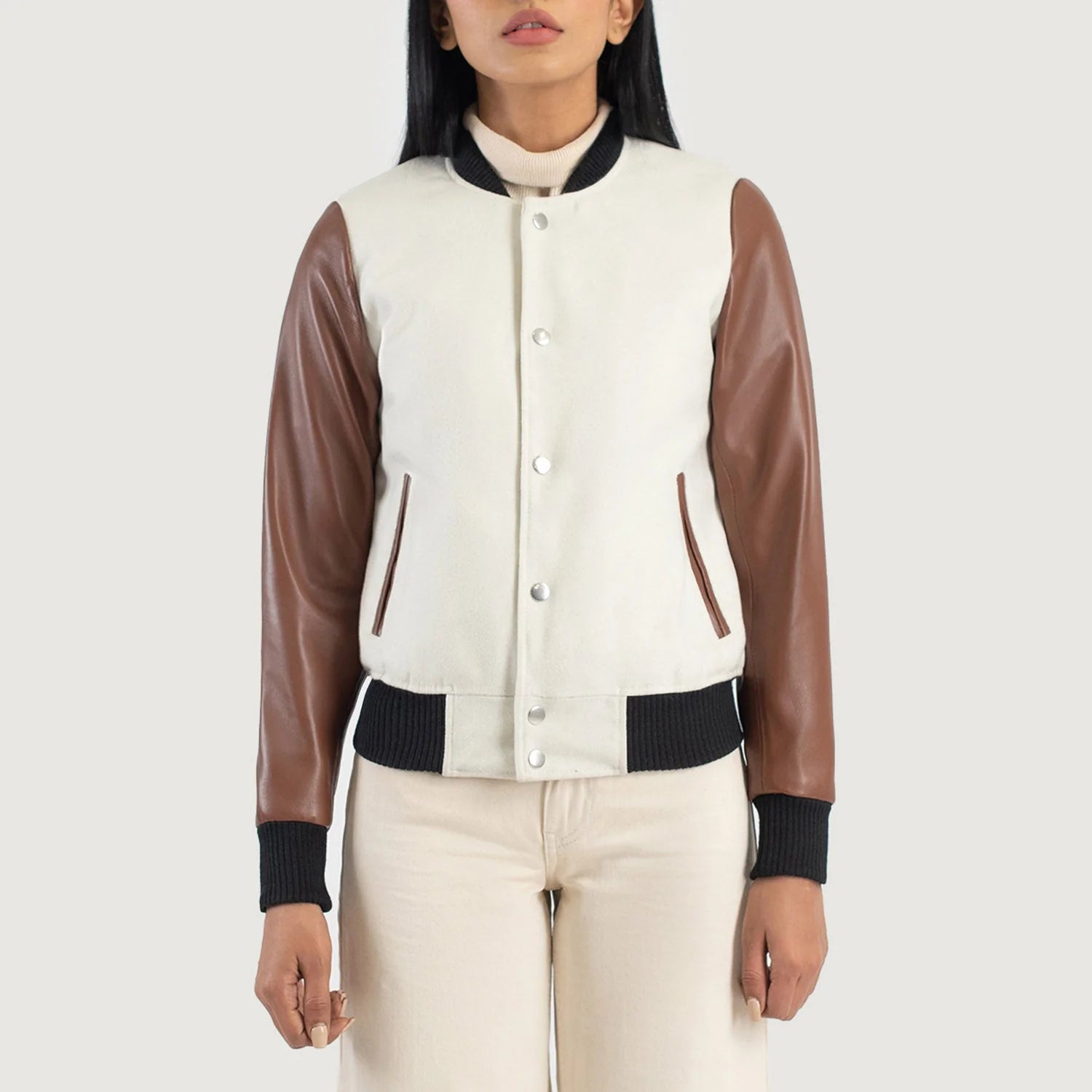 Savant White & Brown Hybrid Varsity Jacket with brown sleeves and button closure on female model