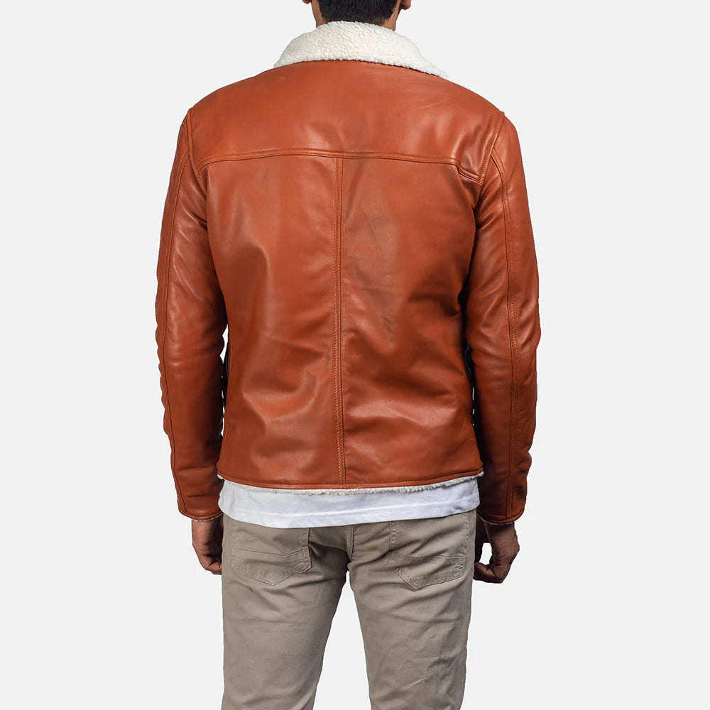 Back view of tan shearling leather jacket worn by man with white shearling collar and tan pants