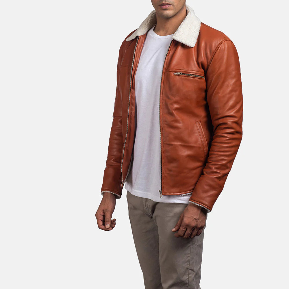 Tan shearling leather jacket with white collar worn by man in white t-shirt and tan pants
