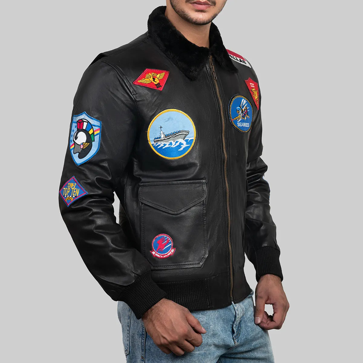 Top Gun Maverick bomber jacket by Lush Gear in black leather with multiple colorful patches and fur collar