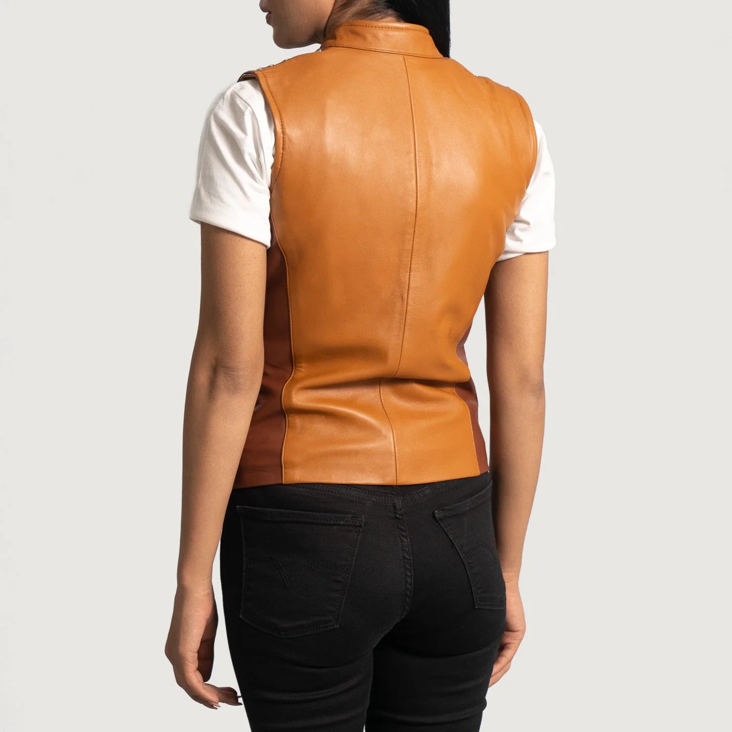 Back view of Westina Tan Dye Leather Vest worn by model over white shirt and black pants