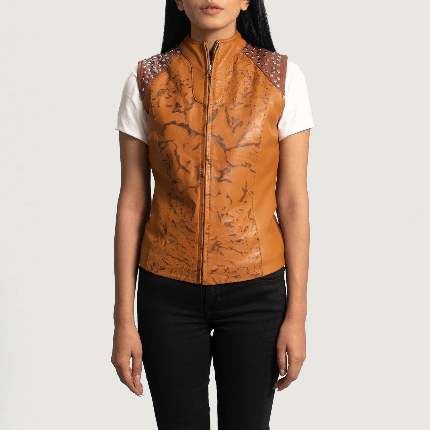 Woman wearing Westina Tan Dye Leather Vest with studded shoulders over white short sleeve shirt