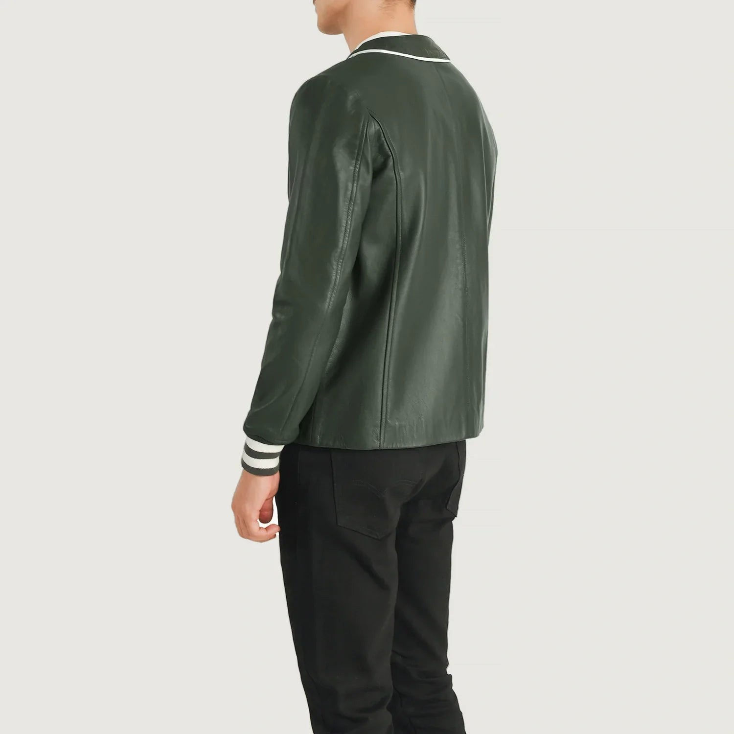 Back view of a person wearing a green Willis varsity jacket for sale with white trim by Lush Gear