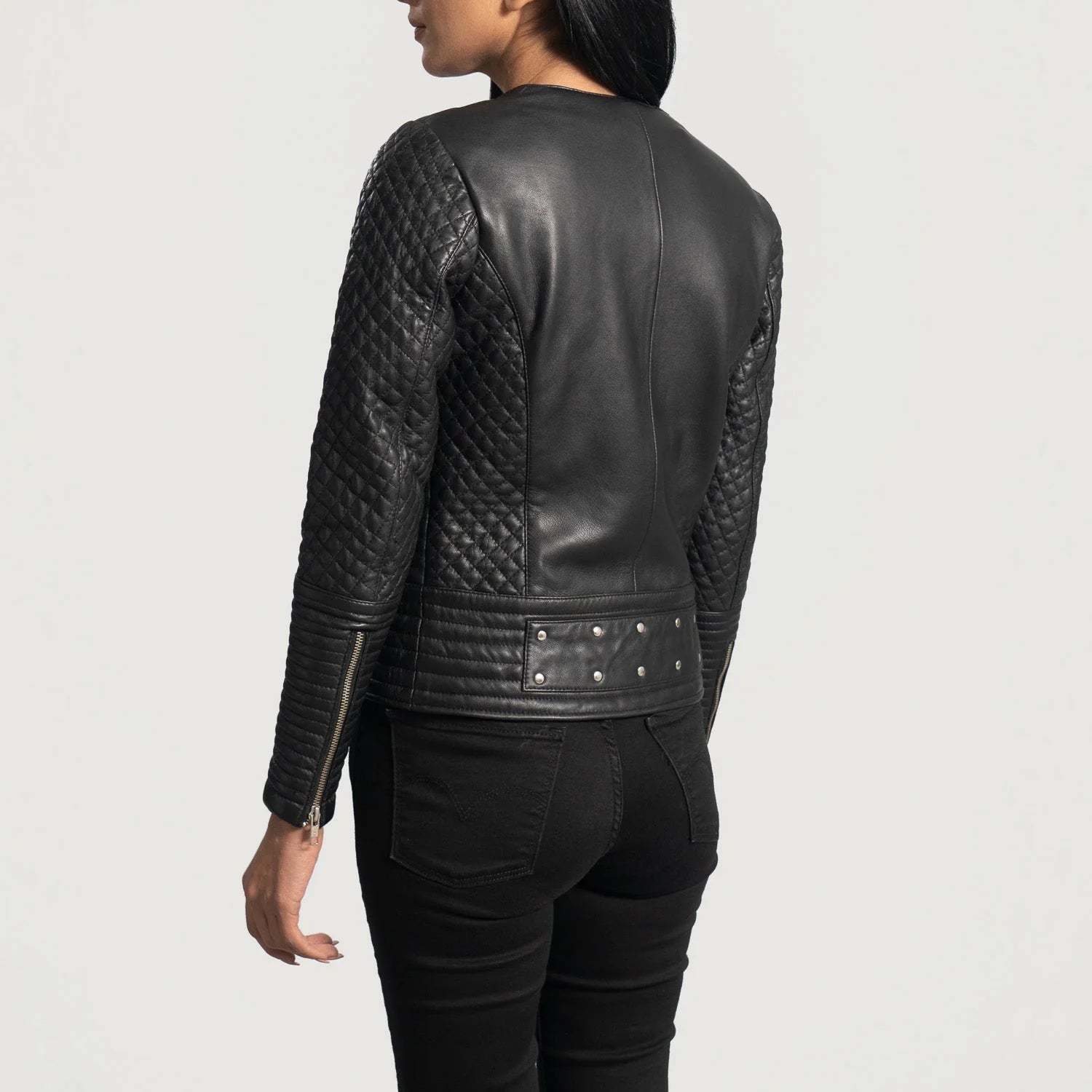 Back view of a women's biker leather jacket by Lush Gear with quilted sleeves and studded details