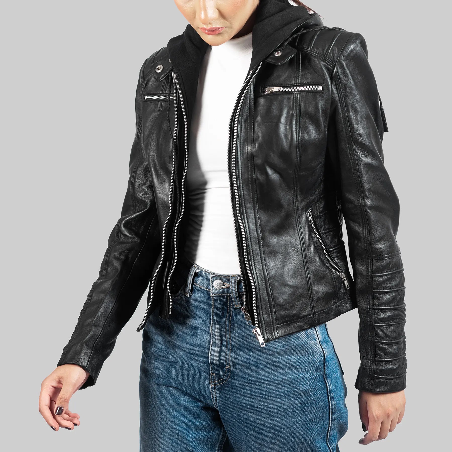 Lush Gear women's black biker leather jacket with zipper pockets and quilted sleeves worn with jeans