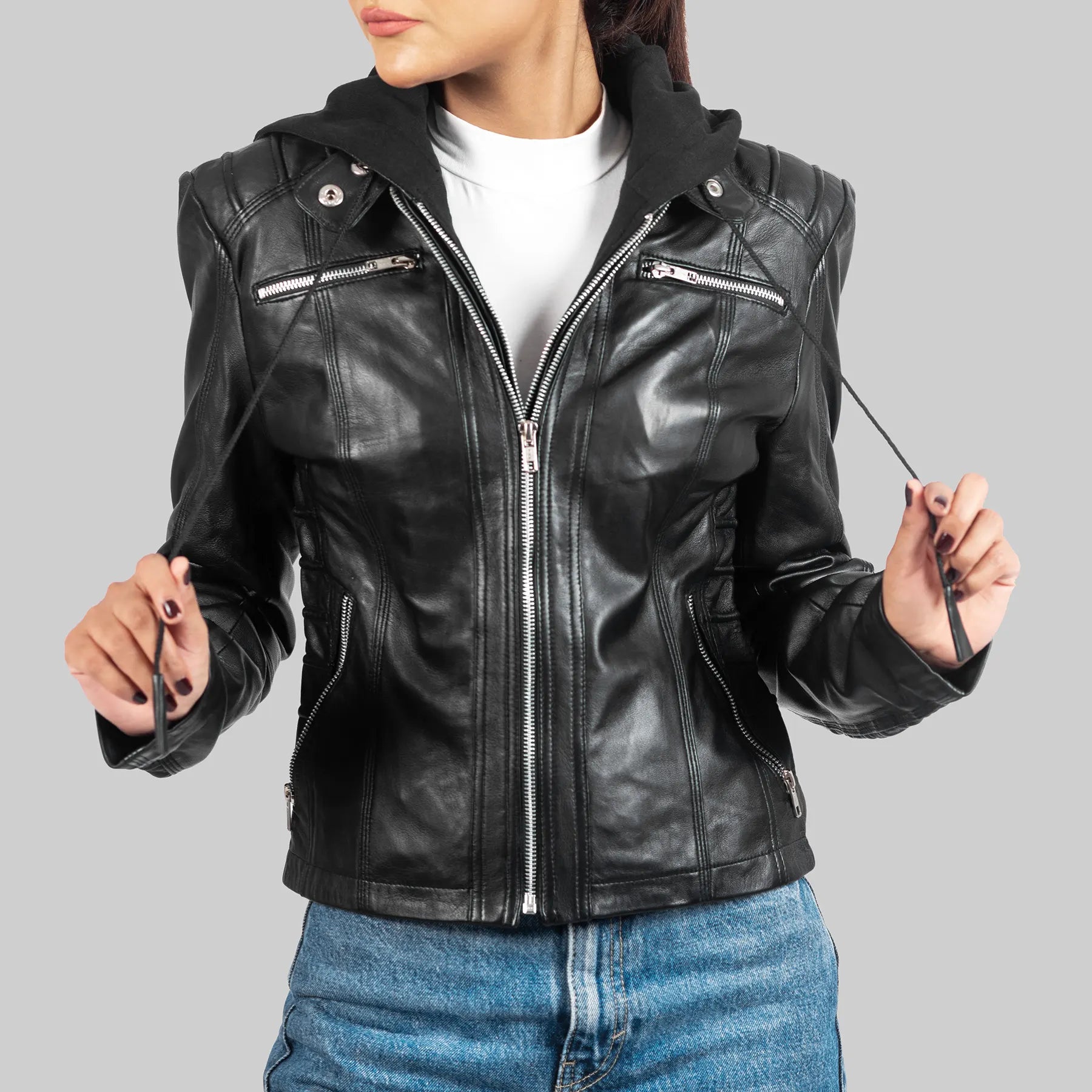 Lush Gear women's black biker leather jacket with zipper and hood worn with blue jeans