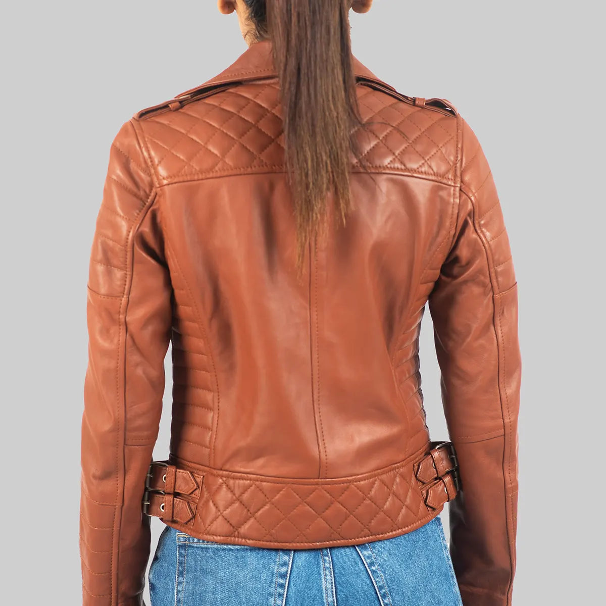 Back view of women's brown leather biker jacket by Lush Gear with quilted detailing and buckles