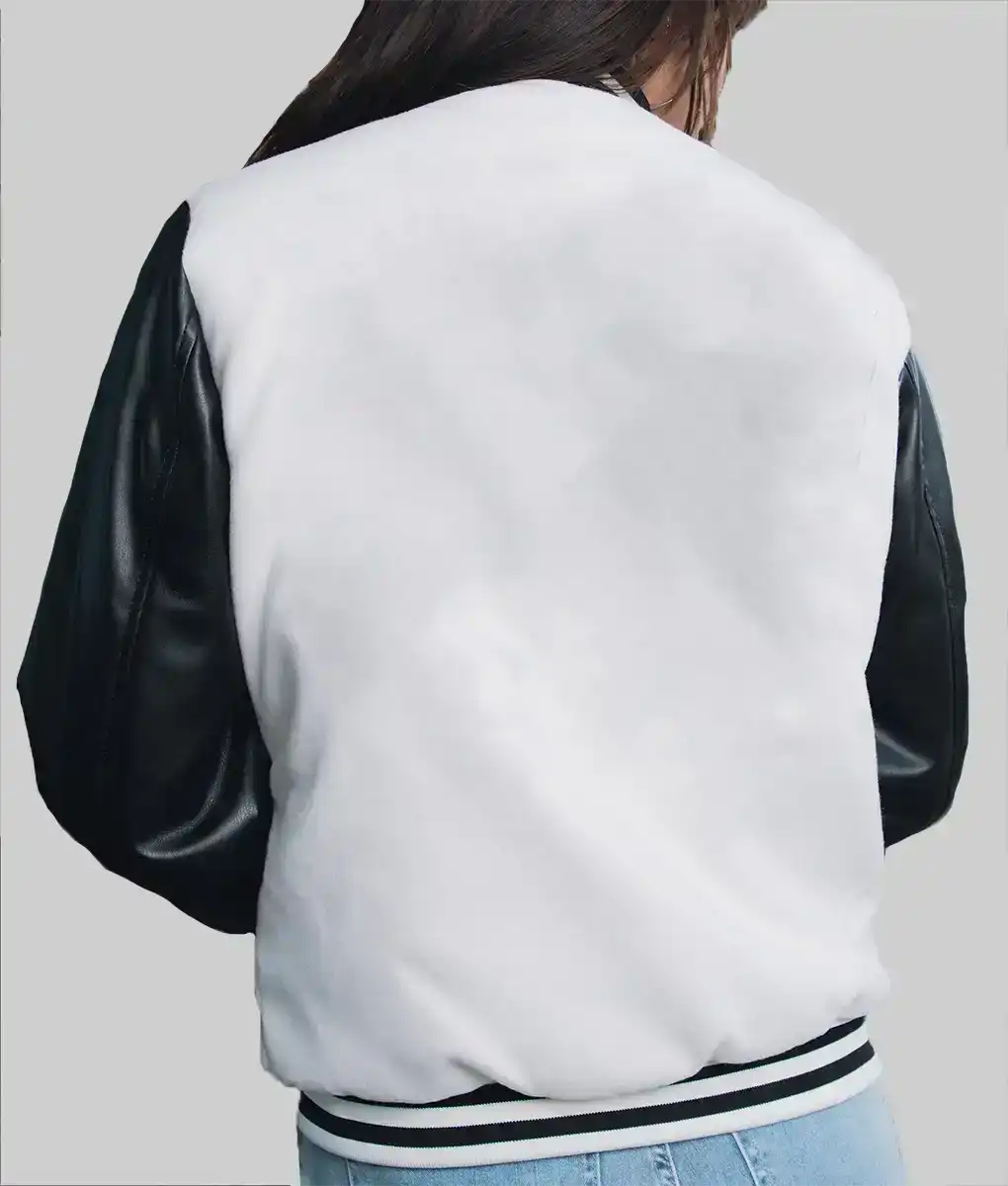 Back view of women's leather varsity jacket with black sleeves and white body worn by a model